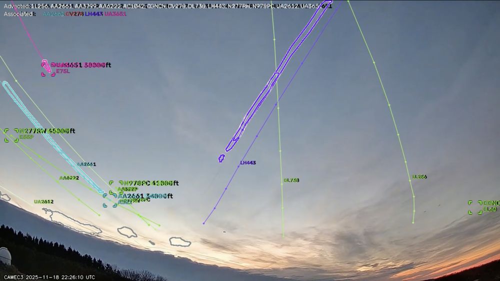 Evening sky with several contrails, each outlined and labelled with the flight number and altitude of the aircraft that made it