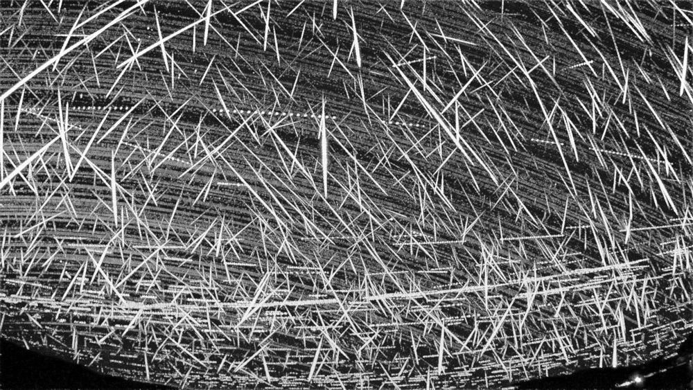 Stacked image of hundreds of meteor streaks radiating from one point in the sky